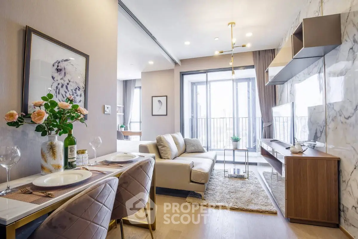 Modern living room with elegant decor and large windows offering natural light and a cozy atmosphere.