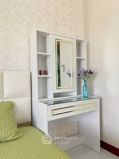 Elegant bedroom with stylish vanity and floral decor