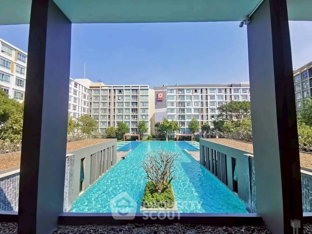 Luxurious apartment complex with stunning pool view and modern architecture.