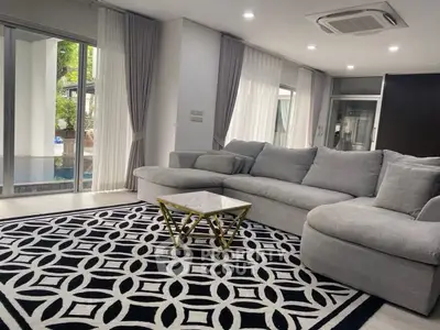 Spacious modern living room with elegant decor and poolside view