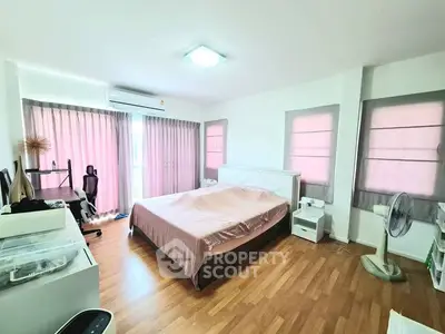 Spacious bedroom with modern decor and natural light