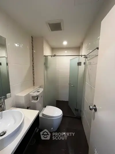 Modern bathroom with glass shower and sleek fixtures