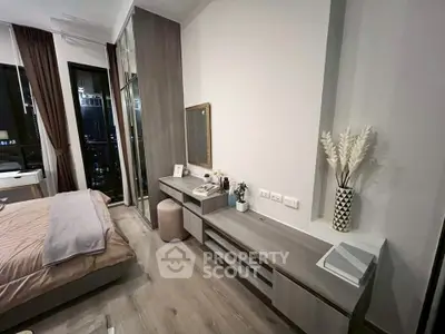 Modern bedroom with stylish decor and city view from large windows