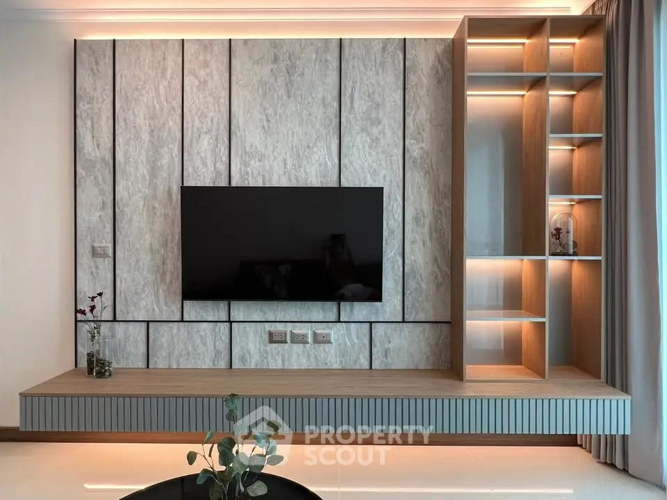 Modern living room with sleek TV wall unit and ambient lighting