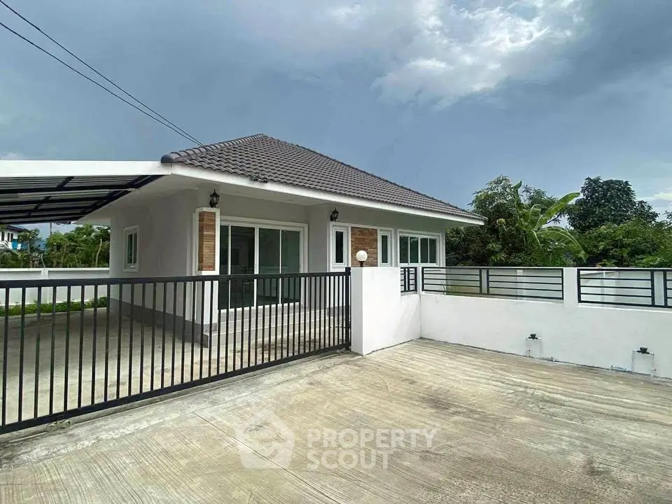 Charming single-story house with modern design and spacious driveway in serene neighborhood.