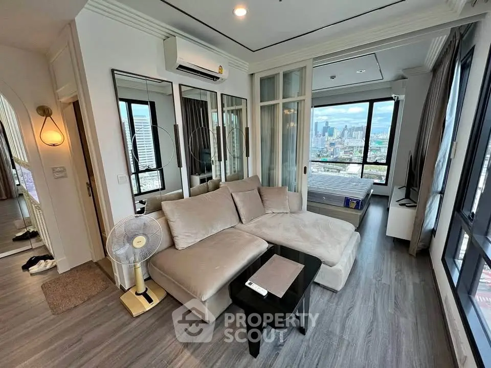 Modern living room with city view, featuring cozy sofa and sleek decor.