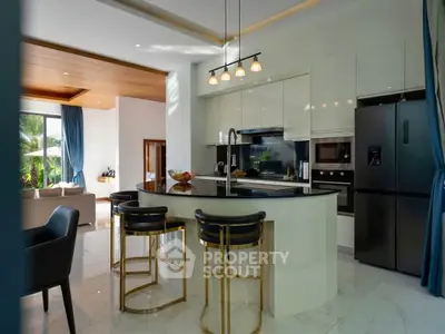 Luxurious modern kitchen with sleek design and open layout, featuring high-end appliances and elegant lighting.