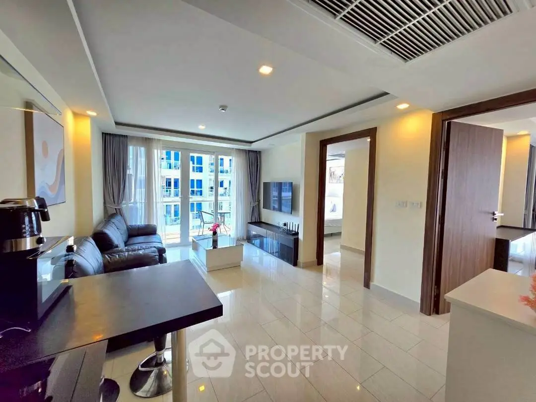 Modern living room with sleek furniture and large windows in a contemporary apartment.