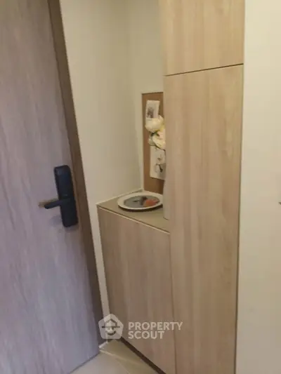 Cozy entryway with wooden cabinetry and modern door handle