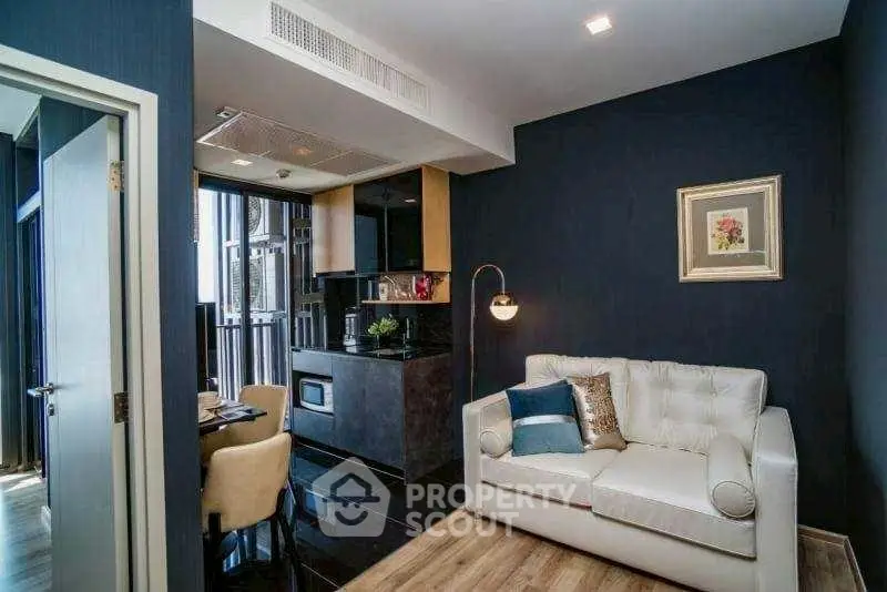 Modern living room with stylish decor and open kitchen layout in luxury apartment.