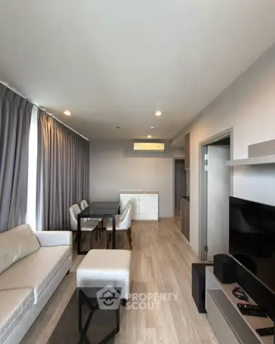 Modern living room with sleek furniture and natural light, perfect for relaxation and entertainment.