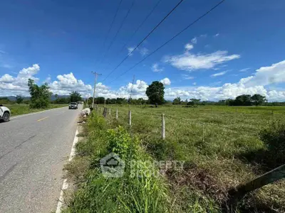 Scenic rural land with road access and open sky, ideal for development or agriculture.