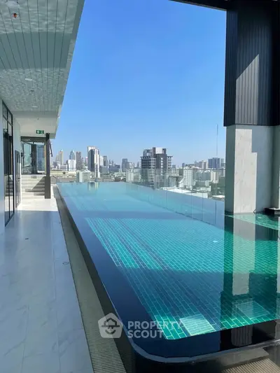 Luxurious rooftop infinity pool with stunning city skyline views, perfect for relaxation and leisure in urban living.