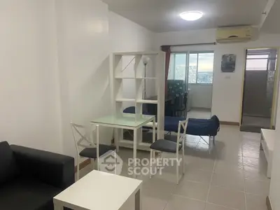 Spacious open-plan living room with modern furniture and city view.