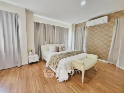Spacious bedroom with elegant decor and natural light