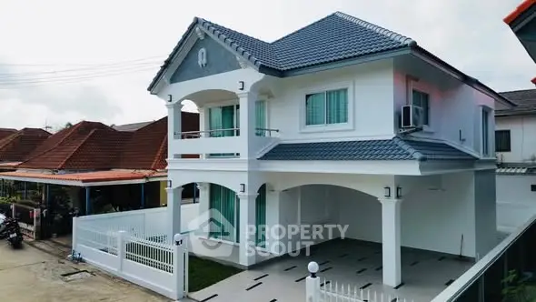 Elegant two-story house with modern design and spacious driveway in a serene neighborhood.