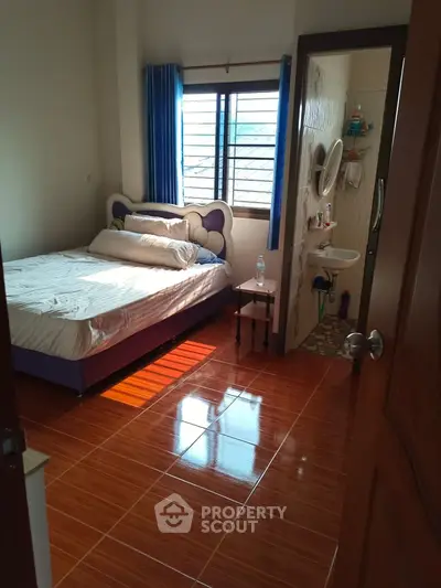Cozy bedroom with ensuite bathroom and natural light