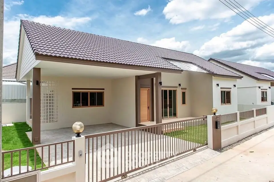 Modern single-story house with tiled roof and spacious driveway