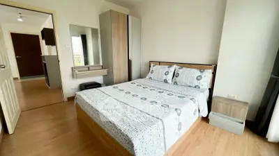 Modern bedroom with stylish decor and wooden flooring in a cozy apartment.