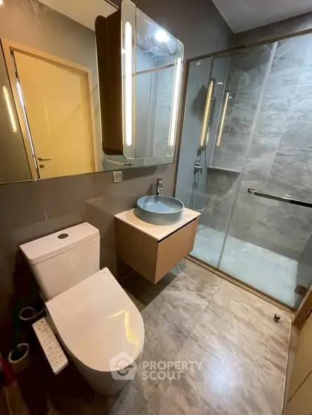 Modern bathroom with sleek fixtures and spacious shower area.