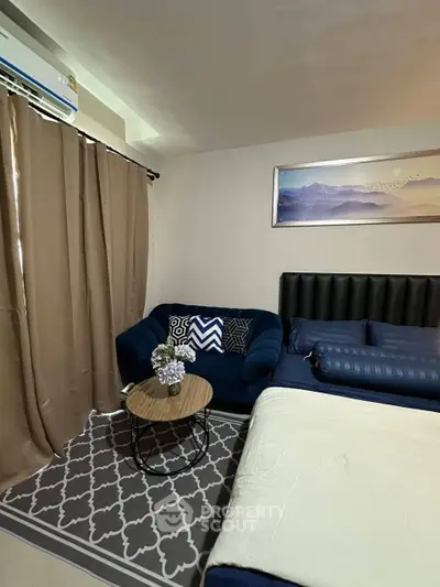 Cozy bedroom with stylish decor and comfortable seating area