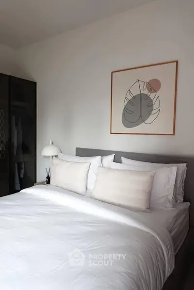 Cozy bedroom with modern decor and stylish artwork above the bed