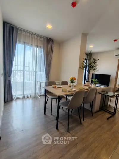 Modern dining area with elegant decor and natural light in a stylish apartment.