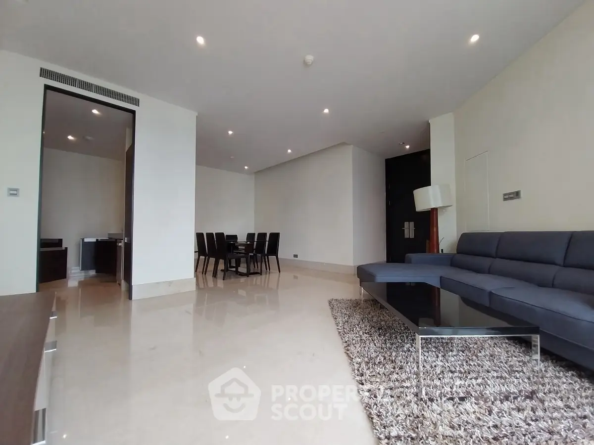 Spacious modern living room with elegant dining area and plush seating.