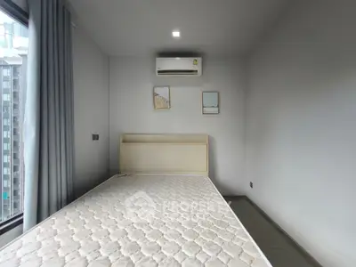 Modern minimalist bedroom with large window and air conditioning