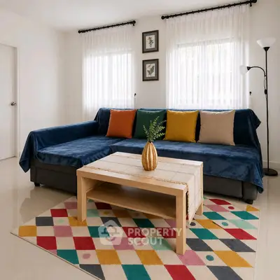 Stylish living room with colorful rug and cozy sofa, perfect for modern living.