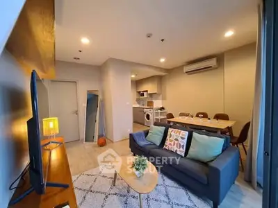 Modern living room with cozy seating and open kitchen layout