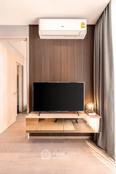 Modern living room with sleek TV setup and stylish wood paneling