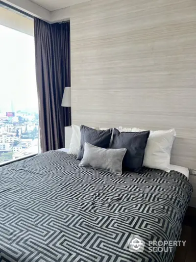 Luxurious bedroom with city view and modern decor in high-rise apartment