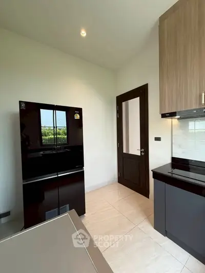 Modern kitchen with sleek black appliances and elegant cabinetry