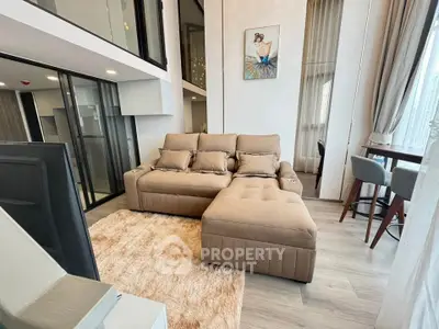 Modern living room with plush sectional sofa and stylish decor in a high-rise apartment.