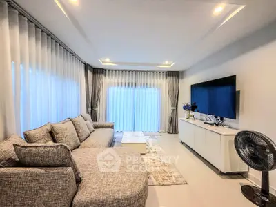 Spacious modern living room with elegant decor and large windows