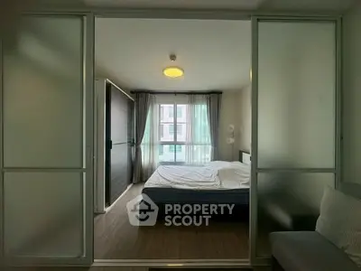 Modern bedroom with sliding glass doors and natural light