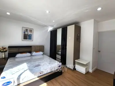 Spacious bedroom with modern decor and ample natural light