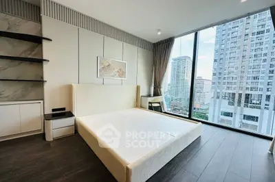 Modern bedroom with floor-to-ceiling windows offering stunning city views
