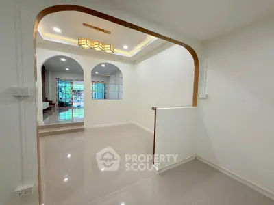 Spacious modern interior with elegant archways and glossy tiled floors