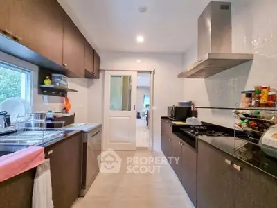 Modern kitchen with sleek cabinetry and gas stove in a spacious home.