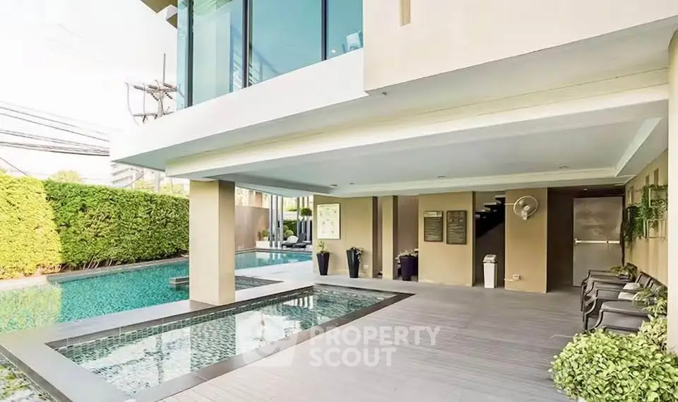 Luxurious modern poolside area with sleek design and lush greenery, perfect for relaxation and entertainment.