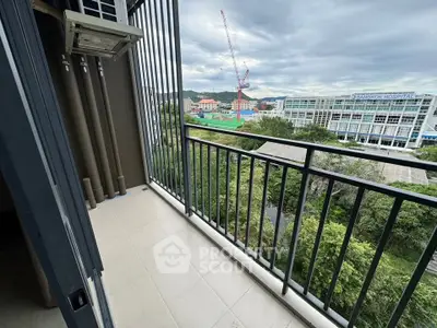 Spacious balcony with scenic view of cityscape and greenery, perfect for relaxation and enjoying the outdoors.