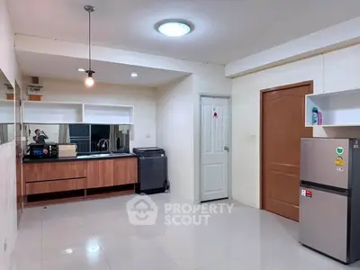 Spacious kitchen with modern appliances and sleek cabinetry in a contemporary apartment.
