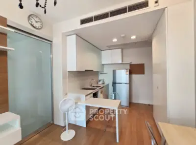Modern kitchen with sleek cabinetry and integrated appliances in a compact layout.