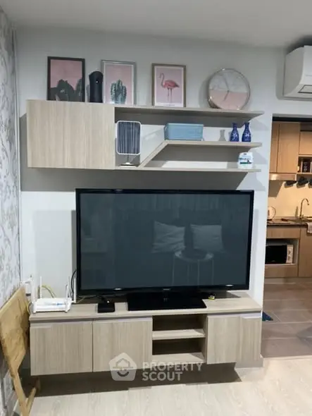 Modern living room with stylish TV unit and open kitchen layout