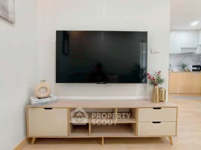 Modern living room with sleek TV setup and stylish wooden furniture
