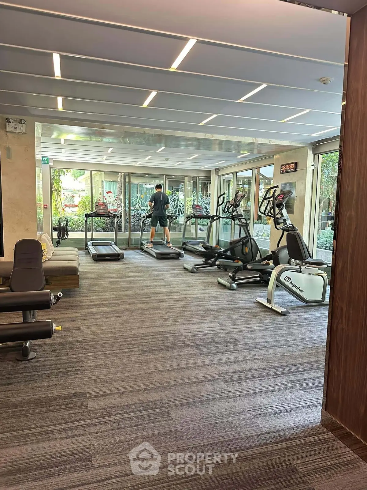 Modern gym with treadmills and exercise equipment in a residential building.