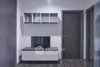 Modern living room with sleek TV stand and wall-mounted shelves