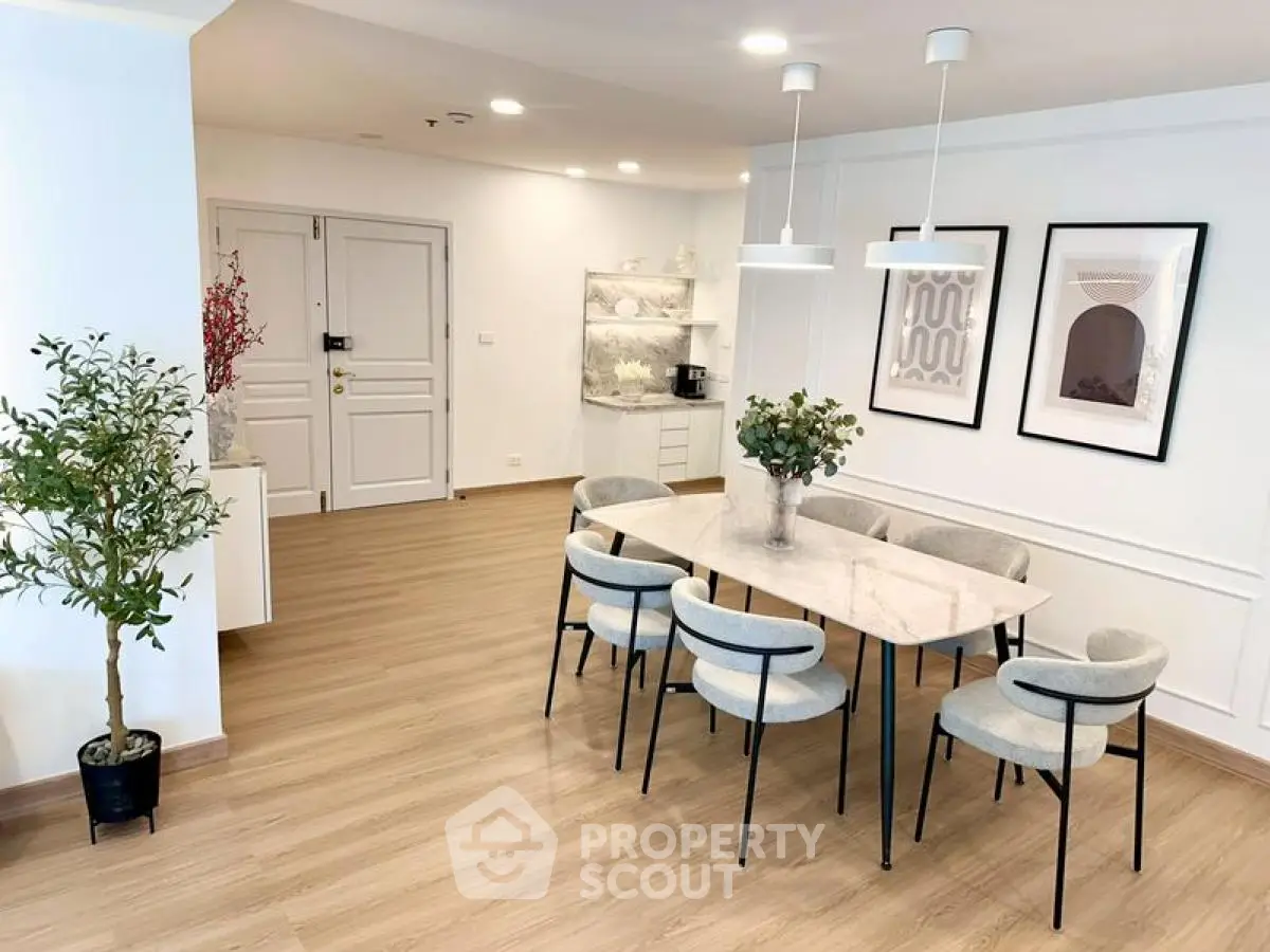 Elegant dining area with modern decor and stylish lighting in a spacious apartment.